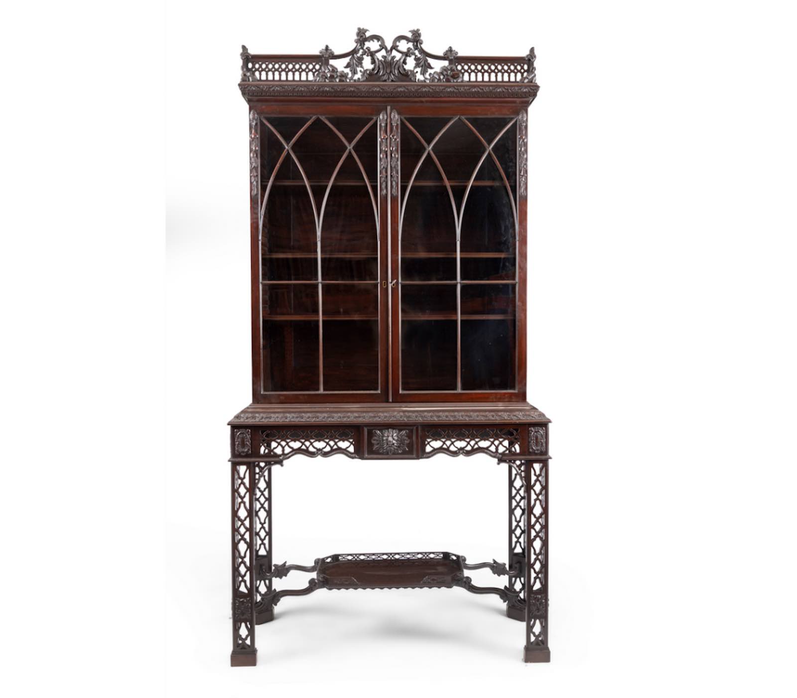 an early 20th century mahogany bookcase on stand in the Chippendale style